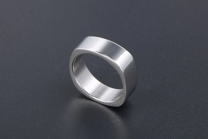 Macro detail of square-round geometric silver ring with a polished mirror finish