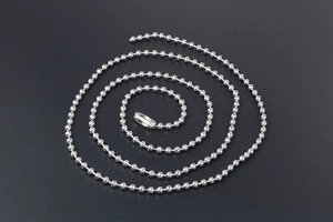Macro view of polished silver titanium steel ball chain with secure connector clasp