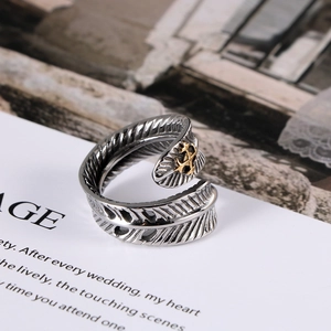 Bague plume vintage en acier titane avec emblème ancre dorée sur carte blanche