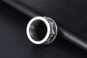 Macro shot of polished titanium steel ring with embossed five-point star patterns