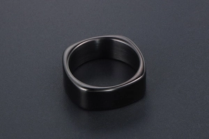 Detail of matte brushed black square ring with rounded corners in a minimalist design