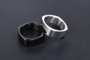 Macro shot of minimalist silver and black square-shaped rings with brushed metal interior