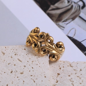 Macro shot of vintage floral hollow carving on an antique gold titanium steel ring
