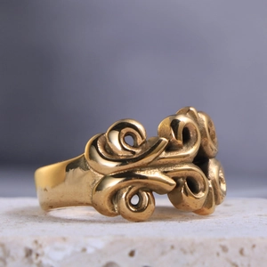 Macro shot of gold vintage ring featuring baroque style engraved scrollwork patterns