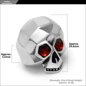 Macro detail of skull ring with faceted forehead and red gemstone eyes in stainless steel