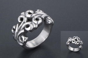 Macro view of vintage style titanium steel ring featuring hollow vine carving patterns