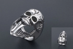 Macro view of vintage punk skull ring with long tongue detail in matte silver finish