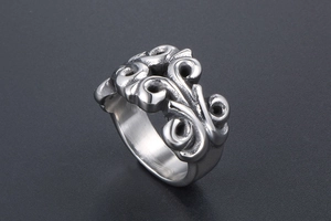 Detail of vintage punk titanium steel ring with baroque scroll carved hollow pattern