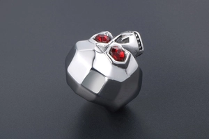 Detail of vintage skull ring with red zircon eyes and geometric faceted back design