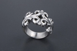 Detailed view of silver hollow carved titanium steel ring with retro floral patterns