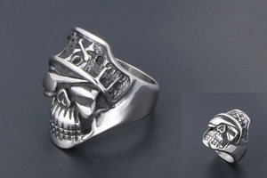 Detailed macro shot of vintage punk pirate skull ring in polished titanium steel