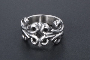 Close-up of gothic vintage wide band ring with intricate baroque scrollwork relief