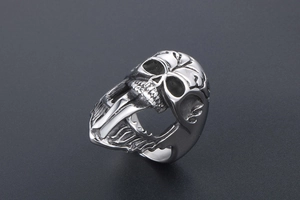 Detailed close-up of a punk-style stainless steel skull ring with long tongue design