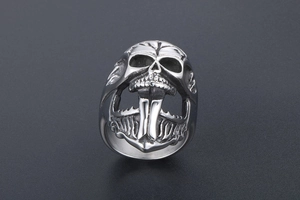 Detailed macro view of punk skull ring with anchor design in polished vintage silver steel