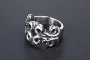 Detail of vintage gothic scroll pattern engraving on a wide titanium steel ring