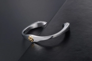 Detail of vintage native style steel bracelet with eagle gold emblem and feather engraving