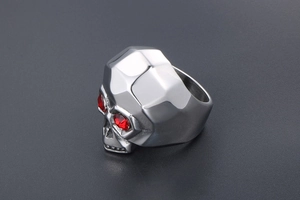 Detail view of gothic skull ring in silver stainless steel with red gemstone eyes