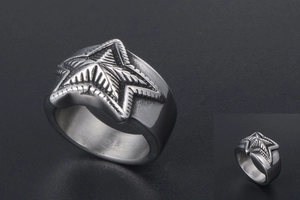 Macro shot of vintage stainless steel star ring with distressed texture and wide band detail