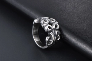 Macro shot of vintage style hollow carved titanium steel ring with intricate vine patterns