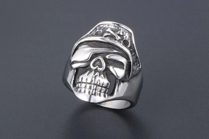 Close-up of vintage pirate skull ring with crossbones and aged silver finish