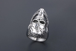 Macro detail of gothic punk skull ring featuring vintage silver flame textures