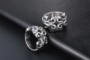Detailed close-up of retro silver titanium steel rings with intricate floral engraving