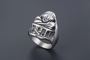 Detail of vintage punk skull ring with crossbones in matte silver titanium steel