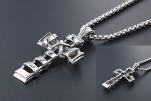 Macro detail of the silver titanium steel cross pendant showing the unique layered ring design