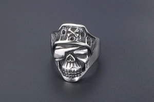 Detailed macro shot of vintage silver pirate skull ring with black distressed finish