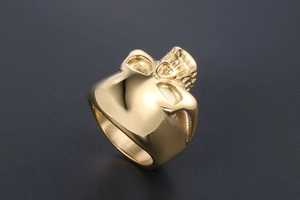 Close-up of a polished gold skull ring for men with reflective metallic finish
