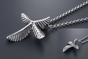 Macro detail of gothic stainless steel leaf cross pendant with thick O-chain link
