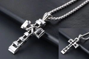 Macro detail of silver tiered cross pendant in titanium steel with solid box chain