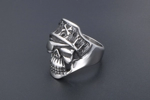 Detailed close-up of a vintage punk skull ring with pirate hat and oxidized finish