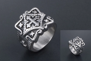 Macro view of vintage stainless steel gothic cross ring with intricate carved relief details