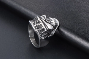 Detailed close-up of a punk pirate skull and crossbones engraved on a steel ring