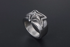 Macro view of vintage stainless steel ring featuring textured pentagram star detailing