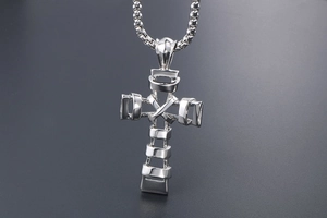 Detailed macro view of silver titanium steel cross pendant with hollow layered structure