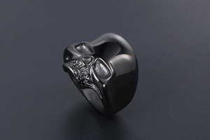 Macro detail of gothic skull ring in gunmetal black with intricate carving details