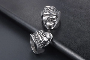 Detailed close-up of retro silver pirate skull rings with eye patches in punk style