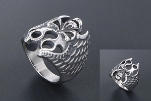 Detailed view of punk skull wings ring in silver stainless steel with gothic textures