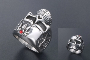 Macro detail of a gothic skull ring with red rhinestone and spider web relief texture