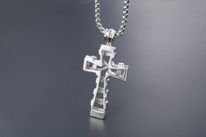 Macro view of silver titanium steel cross pendant with modern geometric hollow design