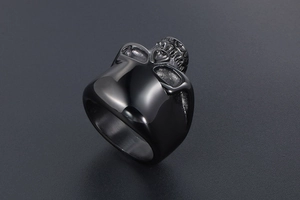 Macro detail of matte black skull ring showing intricate facial bone texture and rock style