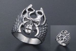 Macro side view of gothic skull ring with flame hollow patterns and scale textures