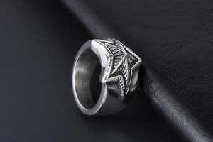 Macro detail of star ring with industrial brushed finish and wide metal band