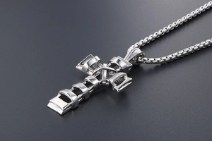 Detailed macro shot of silver stainless steel cross pendant with faceted architectural design