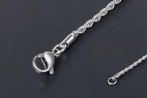 Macro shot of silver stainless steel rope chain with a secure lobster clasp closure