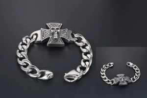 Detailed macro view of the punk skull and iron cross centerpiece on a Cuban link chain