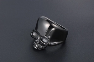 Detailed close-up of a punk-style skull ring in polished dark grey stainless steel