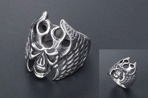 Detailed macro view of vintage gothic skull ring with intricate wing patterns on sides